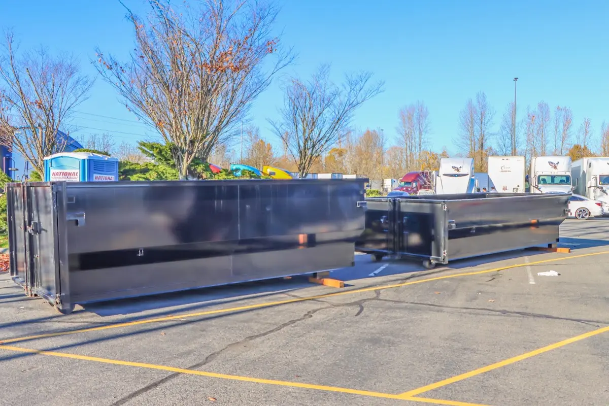 Professional dumpster rental service with roll-off container on residential driveway in Palm Desert